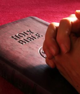 Bible and praying hands
